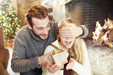 Couple exchanging gifts on Christmas - CAIF15375