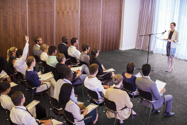 Mid adult businesswoman giving presentation in conference room - CAIF15419