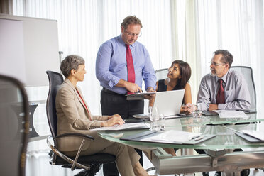 Businessman giving presentation during business meeting - CAIF15434