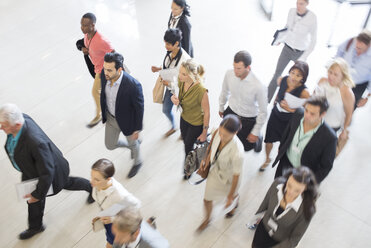 High angle view of business people walking in office - CAIF15438