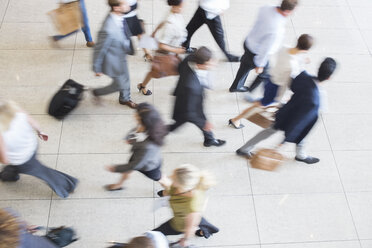 High angle view of business people walking in office on tiled floor - CAIF15464