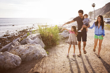 Happy family walking at beach against sky - CAVF07112