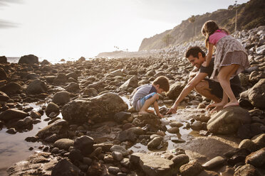 Father with children enjoying at beach during sunset - CAVF07118