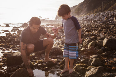 Father and son at beach during sunset - CAVF07124