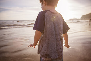Midsection of boy at beach during sunset - CAVF07141