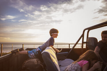 Familie in Pick-up-Truck am Meer bei Sonnenuntergang - CAVF07153