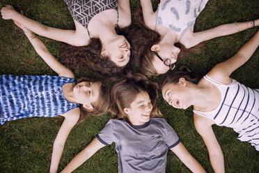 High angle view of friends lying on grass - CAVF07253