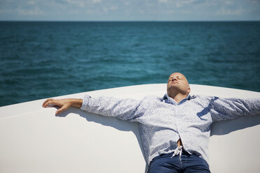 Man relaxing on deck of yacht - CAVF07357