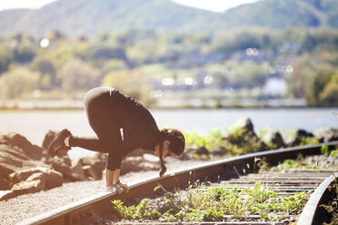 Woman exercising on railroad track - CAVF07747