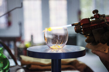 Ausgeschnittenes Bild eines Glasbläsers, der in einer Werkstatt Glas herstellt - CAVF07760