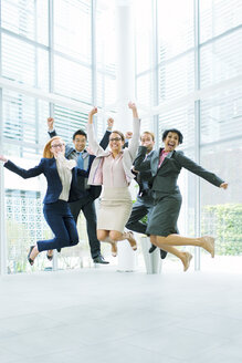 Business people jumping in office building - CAIF15751
