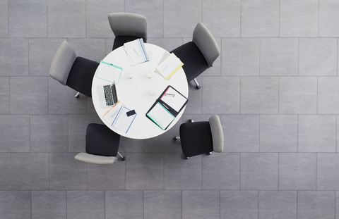 Paperwork scattered on meeting table in office building stock photo