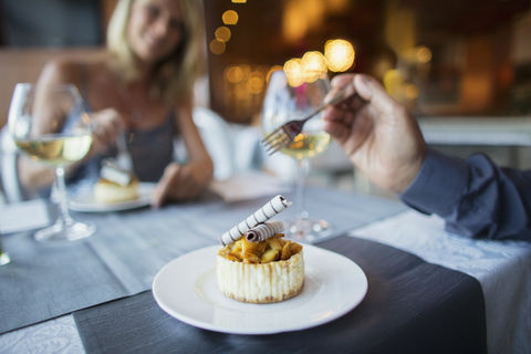 Couple eating dessert in fancy restaurant stock photo