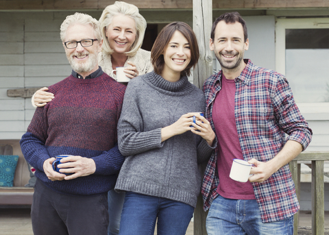 Portrait smiling couples drinking coffee outdoors stock photo