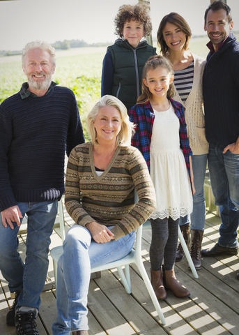Portrait smiling multi-generation family on porch stock photo
