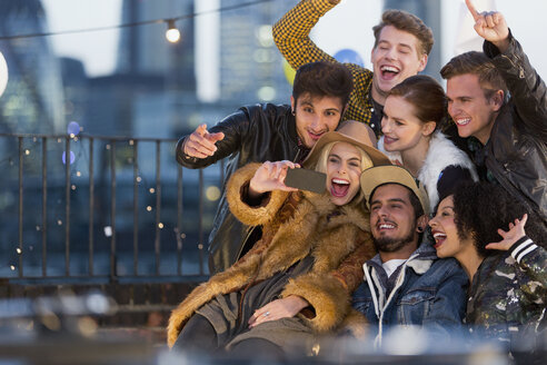 Begeisterte junge Erwachsene machen ein Selfie auf einer Dachterrassenparty - CAIF16118