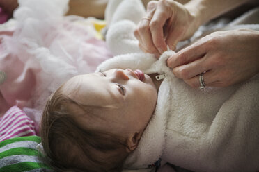 Ausgeschnittenes Bild einer Mutter, die ihre Tochter zu Hause anzieht - CAVF08033