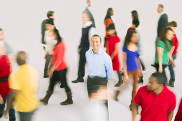 Portrait of smiling businessman standing out from the crowd - CAIF16215