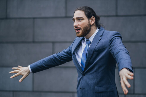 Portrait of businessman standing outdoors gesturing - JSCF00089