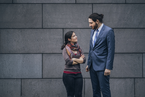 Businessman and woman looking at each other stock photo