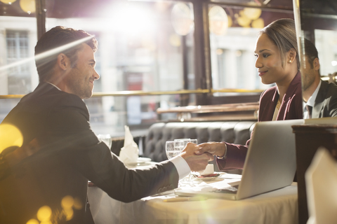 Geschäftsleute beim Händeschütteln im Restaurant, lizenzfreies Stockfoto