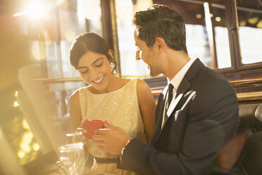 Man proposing to girlfriend in restaurant - CAIF16345