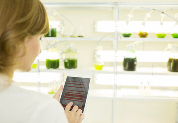 Scientist using digital tablet in laboratory - CAIF16439