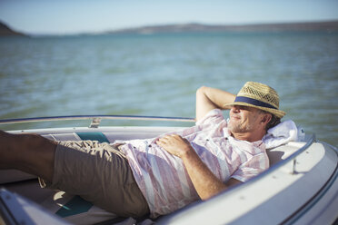 Older man relaxing in boat on water - CAIF16645