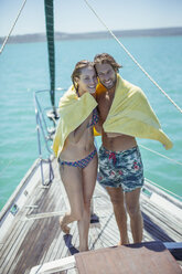 Paar teilt Handtuch im Boot auf dem Wasser - CAIF16651