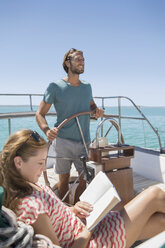 Couple relaxing in boat on water - CAIF16673