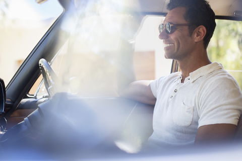 Man driving car on sunny day stock photo
