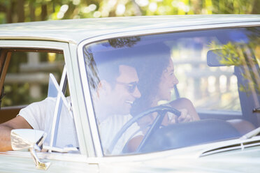 Couple enjoying car ride on sunny day - CAIF16744