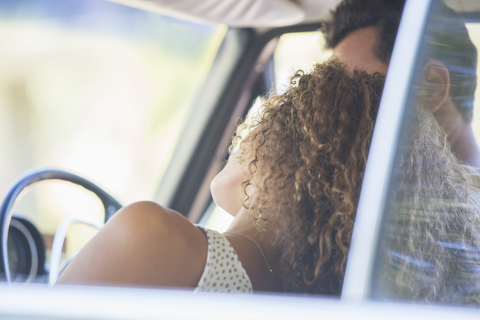 Couple enjoying car ride on sunny day stock photo