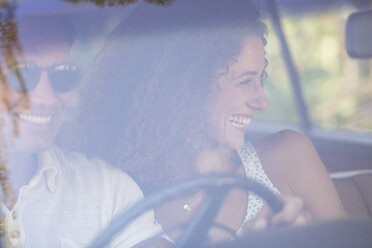 Couple enjoying car ride together on sunny day - CAIF16752