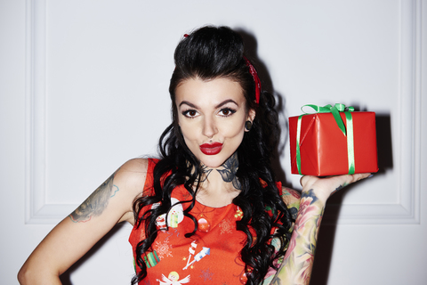 Portrait of tattooed woman with gift stock photo