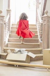 Young girl running up stairs playing - CAIF16801