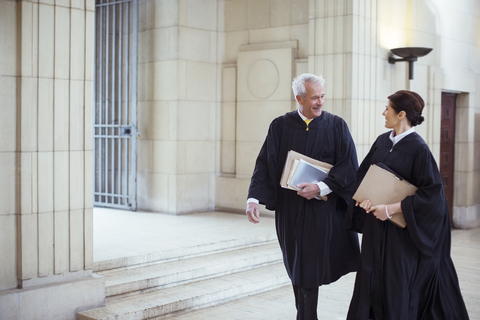 Judges walking through courthouse together stock photo
