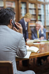 Lawyer talking on cell phone in chambers - CAIF16884