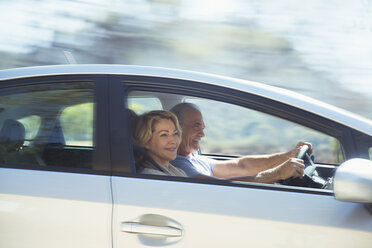Happy senior couple driving in car - CAIF16916