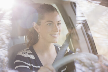 Smiling woman driving car - CAIF16964