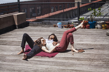 Couple relaxing at building terrace - CAVF09029