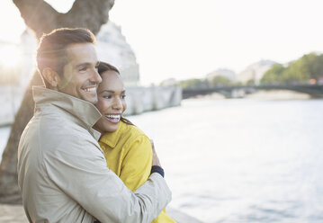 Couple hugging along Seine River, Paris, France - CAIF17050