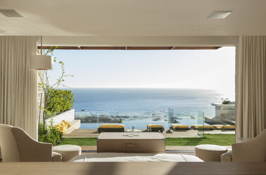 Sunny bedroom and patio overlooking ocean - CAIF17105