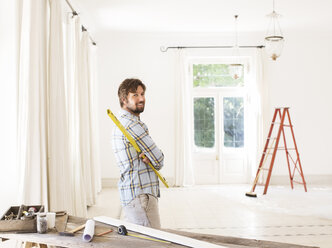 Man overlooking living space near construction materials - CAIF17213