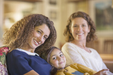 Three generations of women relaxing on couch together - CAIF17287