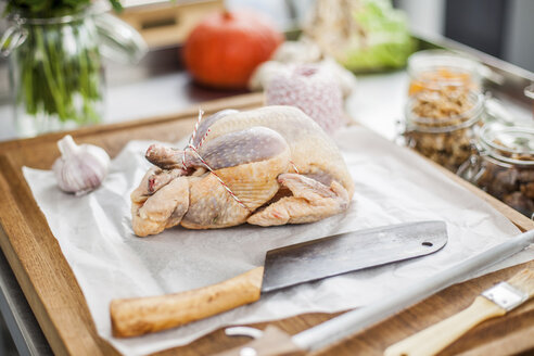 Uncooked filled chicken on chopping board - KVF00106