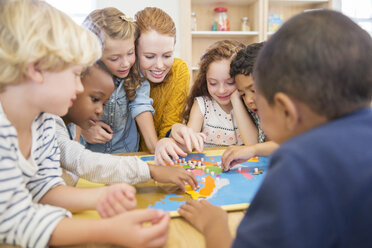 Lehrerin spielt mit Schülern im Klassenzimmer - CAIF17433