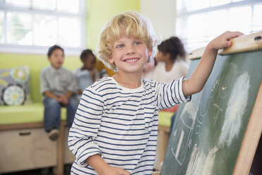 Schülerin zeichnet auf Kreidetafel im Klassenzimmer - CAIF17442