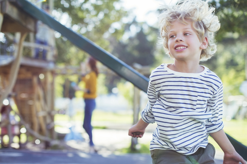 Junge spielt auf dem Spielplatz, lizenzfreies Stockfoto