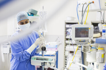 Nurse standing by medical and monitoring equipment - CAIF17502